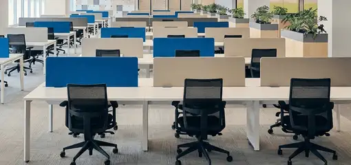 Modern open-plan office space featuring clean workstations, ergonomic chairs, and sanitized carpets provided by professional office cleaning services in Fort Lauderdale, FL.