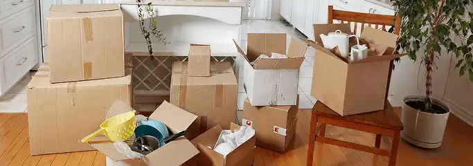 Packed moving boxes and household items in a kitchen before move-out or move-in cleaning, Fort Lauderdale, FL.